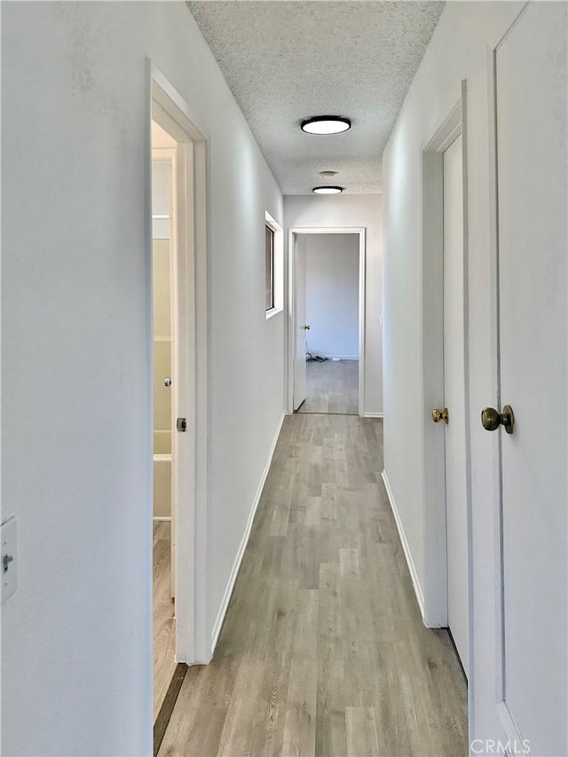2568 Highgate Ct, Chino Hills, CA 91709 - corridor with light wood finished floors and a textured ceiling