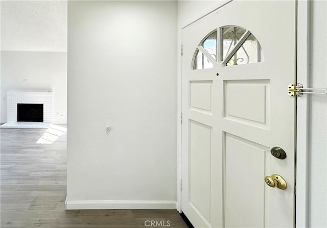 2568 Highgate Ct, Chino Hills, CA 91709 - entrance foyer with wood finished floors and a brick fireplace