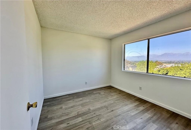 2568 Highgate Ct, Chino Hills, CA 91709 - unfurnished room featuring wood finished floors, a textured ceiling, and a mountain view