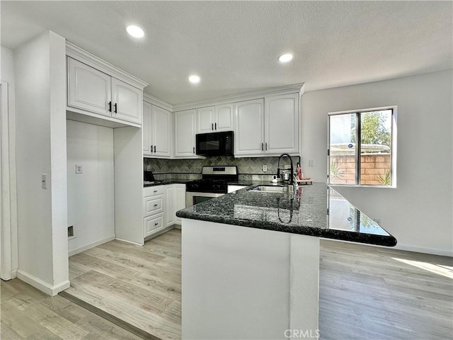 2568 Highgate Ct, Chino Hills, CA 91709 - kitchen with stainless steel gas stove, black microwave, dark stone counters, a peninsula, and light wood-style floors