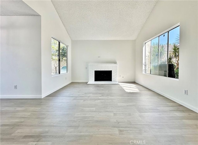 2568 Highgate Ct, Chino Hills, CA 91709 - unfurnished living room with vaulted ceiling, a textured ceiling, wood finished floors, and a fireplace