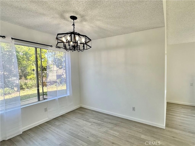2568 Highgate Ct, Chino Hills, CA 91709 - unfurnished room with a chandelier, a textured ceiling, and wood finished floors