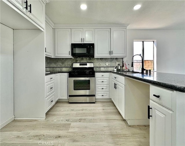 2568 Highgate Ct, Chino Hills, CA 91709 - kitchen with black microwave, stainless steel gas range oven, recessed lighting, backsplash, and white cabinetry