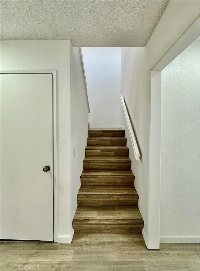 2568 Highgate Ct, Chino Hills, CA 91709 - staircase featuring wood finished floors and a textured ceiling