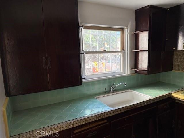 2208 W Olympic Blvd, Montebello, CA 90640 - kitchen with tile counters, backsplash, and dark brown cabinetry