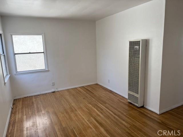 2208 W Olympic Blvd, Montebello, CA 90640 - spare room featuring a heating unit and wood finished floors