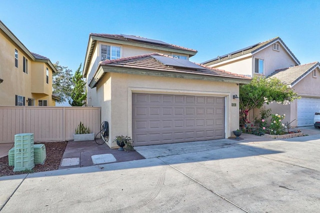 1430 Vallejo Mills St, Chula Vista, CA 91913 - view of front facade featuring stucco siding, driveway, solar panels, and a garage