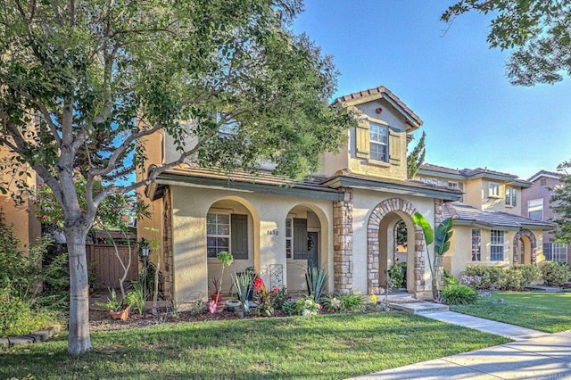 1430 Vallejo Mills St, Chula Vista, CA 91913 - mediterranean / spanish-style home featuring stucco siding, a front lawn, a tile roof, and a porch