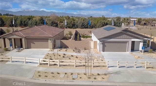 7594 Taylor Ave, Hesperia, CA 92345 - ranch-style home featuring driveway, a fenced front yard, an attached garage, and a tile roof
