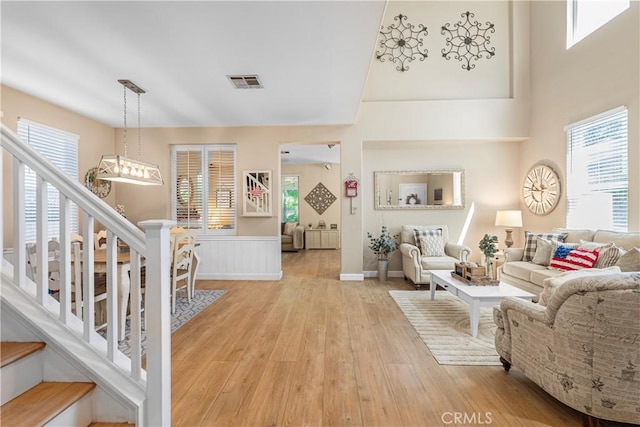 25525 Fitzgerald Ave, Stevenson Ranch, CA 91381 - living area featuring light wood-type flooring, plenty of natural light, and stairs