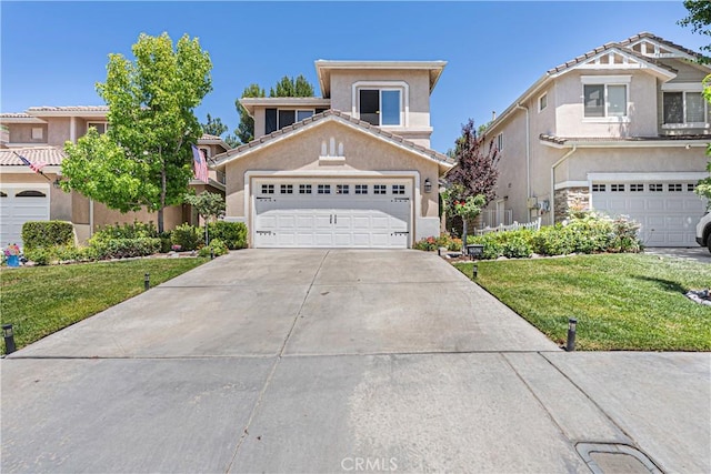25525 Fitzgerald Ave, Stevenson Ranch, CA 91381 - view of front of home with a front lawn, stucco siding, and driveway