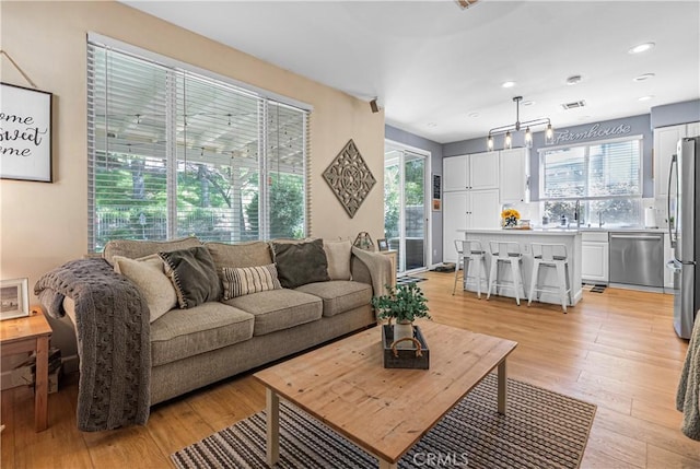 25525 Fitzgerald Ave, Stevenson Ranch, CA 91381 - living room with light wood-style floors and recessed lighting