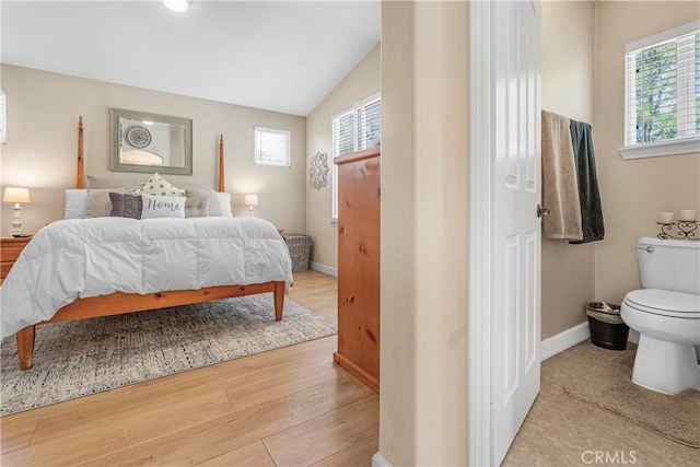 25525 Fitzgerald Ave, Stevenson Ranch, CA 91381 - bedroom featuring multiple windows, wood finished floors, and lofted ceiling