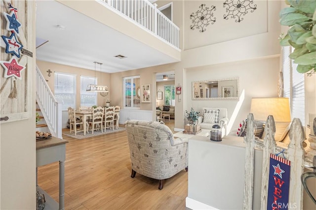 25525 Fitzgerald Ave, Stevenson Ranch, CA 91381 - living room with light wood-style flooring and a chandelier