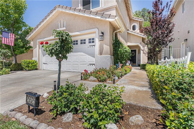 25525 Fitzgerald Ave, Stevenson Ranch, CA 91381 - view of front of property featuring stucco siding, driveway, a garage, and a tile roof