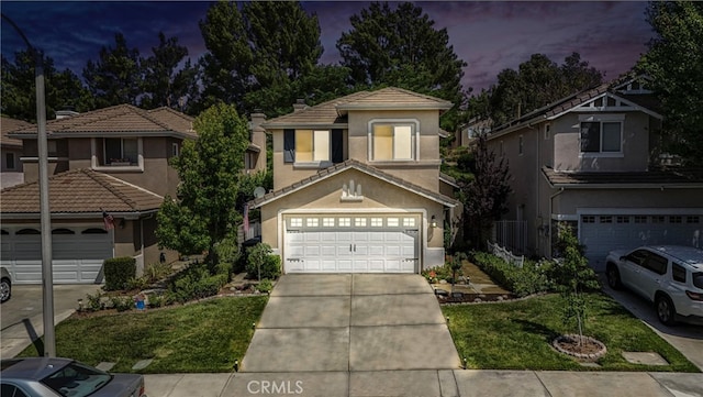 25525 Fitzgerald Ave, Stevenson Ranch, CA 91381 - mediterranean / spanish-style house featuring concrete driveway, stucco siding, a garage, a tiled roof, and a front yard