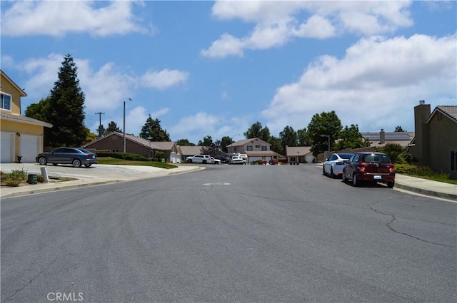 856 Liam Way, Beaumont, CA 92223 - view of asphalt street featuring sidewalks, a residential view, curbs, and street lighting
