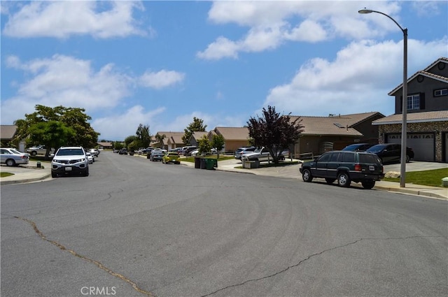 856 Liam Way, Beaumont, CA 92223 - view of asphalt road featuring sidewalks, a residential view, curbs, and street lighting