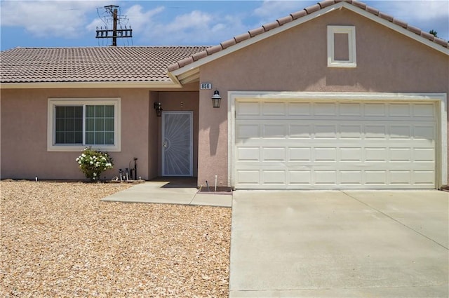 856 Liam Way, Beaumont, CA 92223 - view of front facade with stucco siding, a tile roof, driveway, and an attached garage