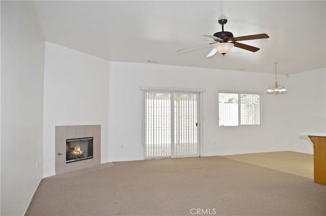 856 Liam Way, Beaumont, CA 92223 - unfurnished living room with carpet, a tiled fireplace, a ceiling fan, and a chandelier