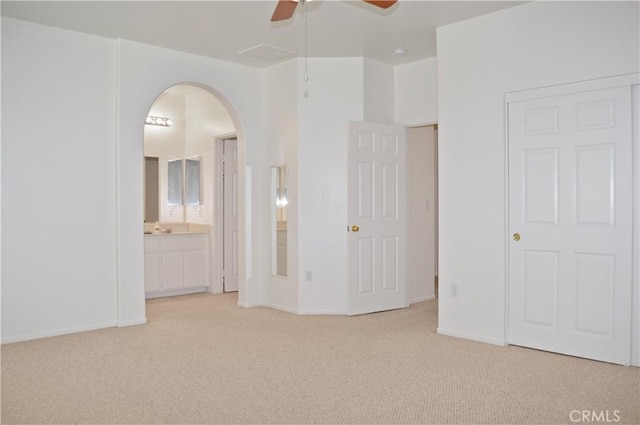 856 Liam Way, Beaumont, CA 92223 - unfurnished bedroom with carpet flooring, arched walkways, ensuite bath, and a ceiling fan