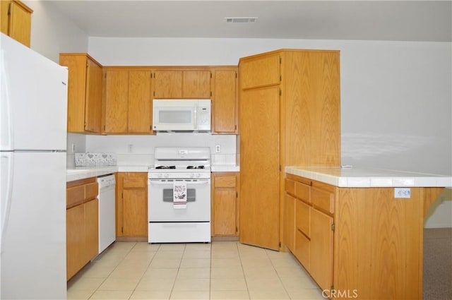 856 Liam Way, Beaumont, CA 92223 - kitchen with white appliances, light countertops, a peninsula, light tile patterned floors, and brown cabinetry