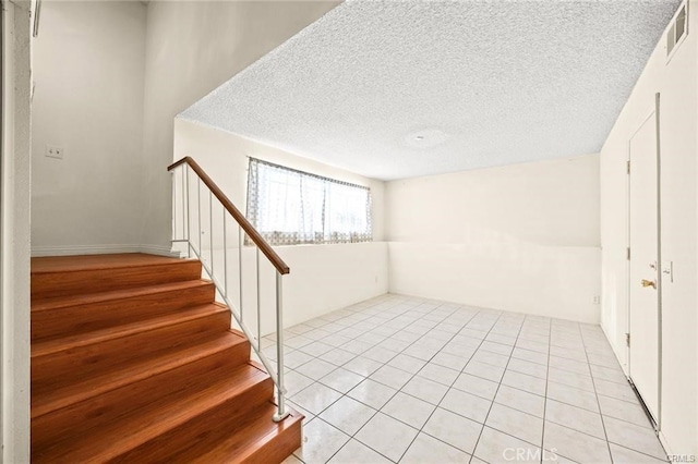 11331 Elliott Ave Unit 21, El Monte, CA 91732 - basement with stairs, a textured ceiling, and light tile patterned flooring