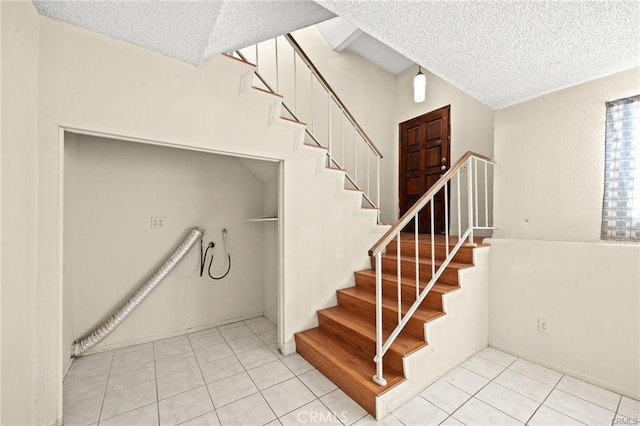 11331 Elliott Ave Unit 21, El Monte, CA 91732 - stairway with a textured ceiling and tile patterned floors