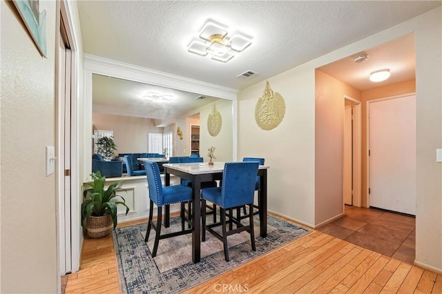 19121 Broken Bow Dr, Riverside, CA 92508 - dining room with hardwood / wood-style flooring and a textured ceiling