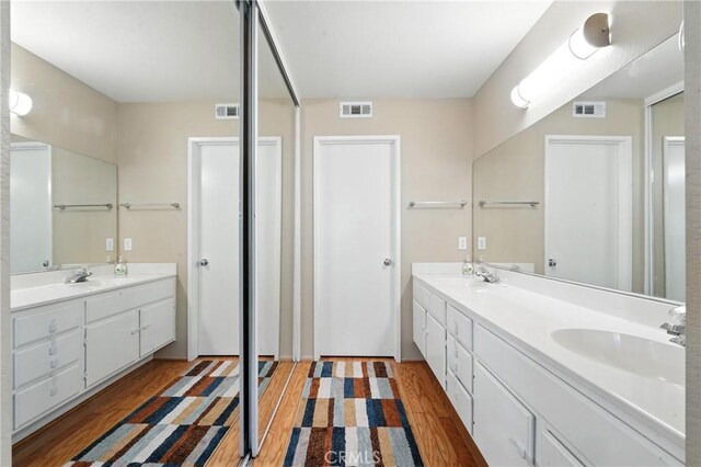 19121 Broken Bow Dr, Riverside, CA 92508 - bathroom featuring double vanity and wood finished floors