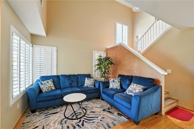19121 Broken Bow Dr, Riverside, CA 92508 - living area with wood finished floors, plenty of natural light, stairway, and a towering ceiling