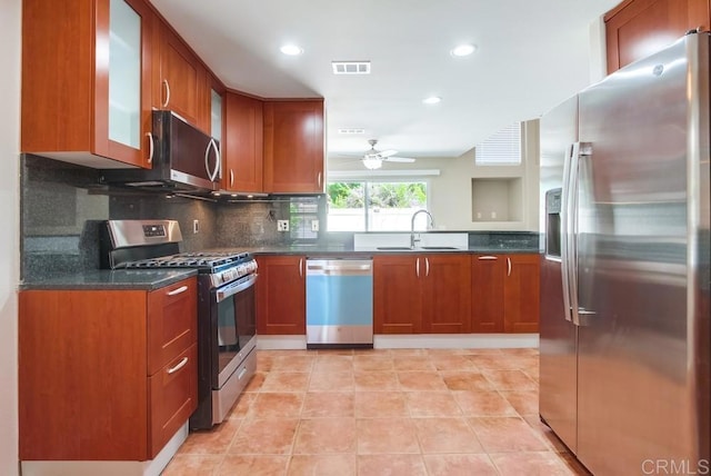 4620 Los Alamos Way Unit C, Oceanside, CA 92057 - kitchen with appliances with stainless steel finishes, ceiling fan, glass insert cabinets, backsplash, and recessed lighting