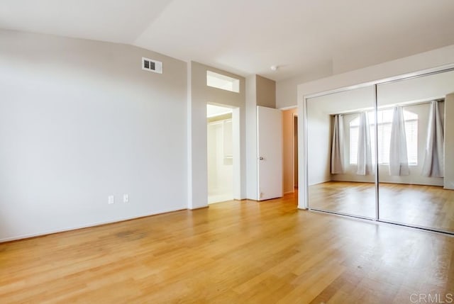 4620 Los Alamos Way Unit C, Oceanside, CA 92057 - unfurnished bedroom with light wood-style floors, lofted ceiling, a closet, and connected bathroom