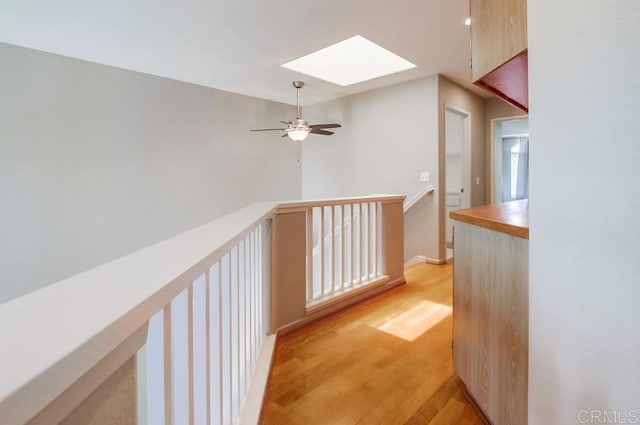 4620 Los Alamos Way Unit C, Oceanside, CA 92057 - hall featuring a skylight, light wood finished floors, and an upstairs landing