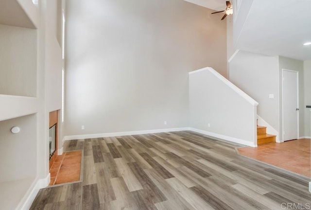 4620 Los Alamos Way Unit C, Oceanside, CA 92057 - unfurnished living room featuring ceiling fan, wood finished floors, and stairway