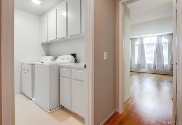 4620 Los Alamos Way Unit C, Oceanside, CA 92057 - washroom with cabinet space, separate washer and dryer, and light wood-style floors