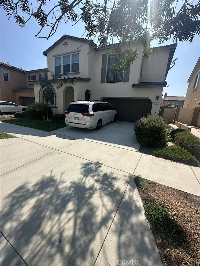 4974 S Rosemary Way, Ontario, CA 91762 - view of front of home featuring an attached garage, concrete driveway, and stucco siding