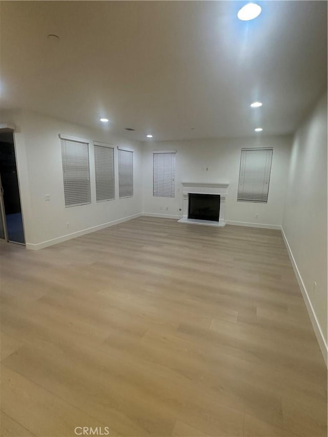 4974 S Rosemary Way, Ontario, CA 91762 - unfurnished living room with light wood-style floors, recessed lighting, and a fireplace with raised hearth