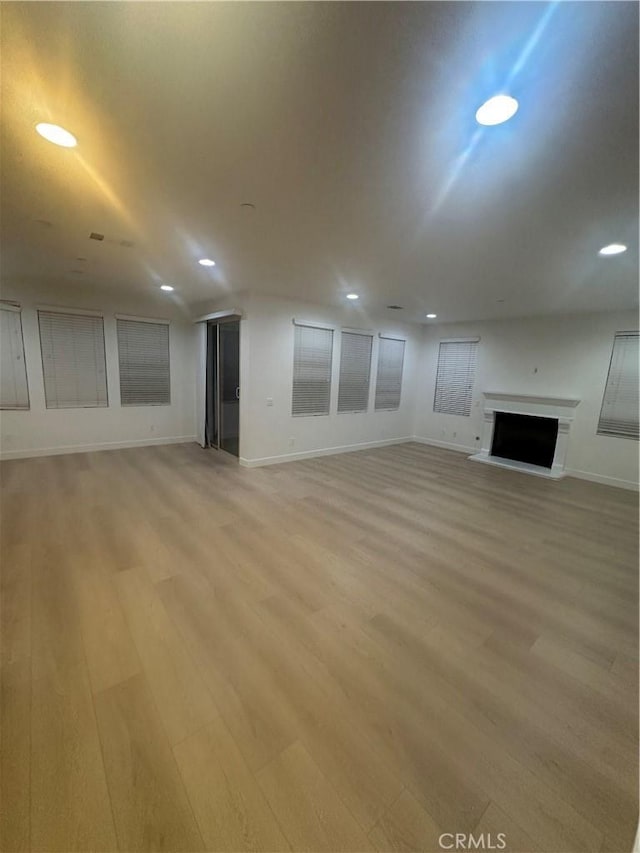 4974 S Rosemary Way, Ontario, CA 91762 - unfurnished living room with light wood-style flooring, a fireplace with raised hearth, and recessed lighting