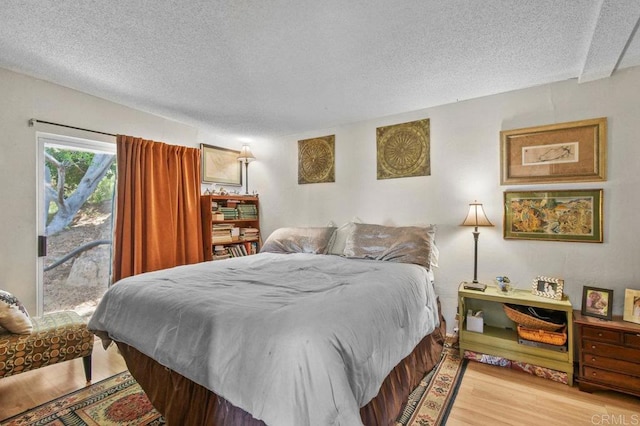 3135 S Bonita St, Spring Valley, CA 91977 - bedroom featuring a textured ceiling, access to outside, and light wood finished floors