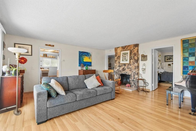 3135 S Bonita St, Spring Valley, CA 91977 - living room featuring a textured ceiling, wood finished floors, and a fireplace