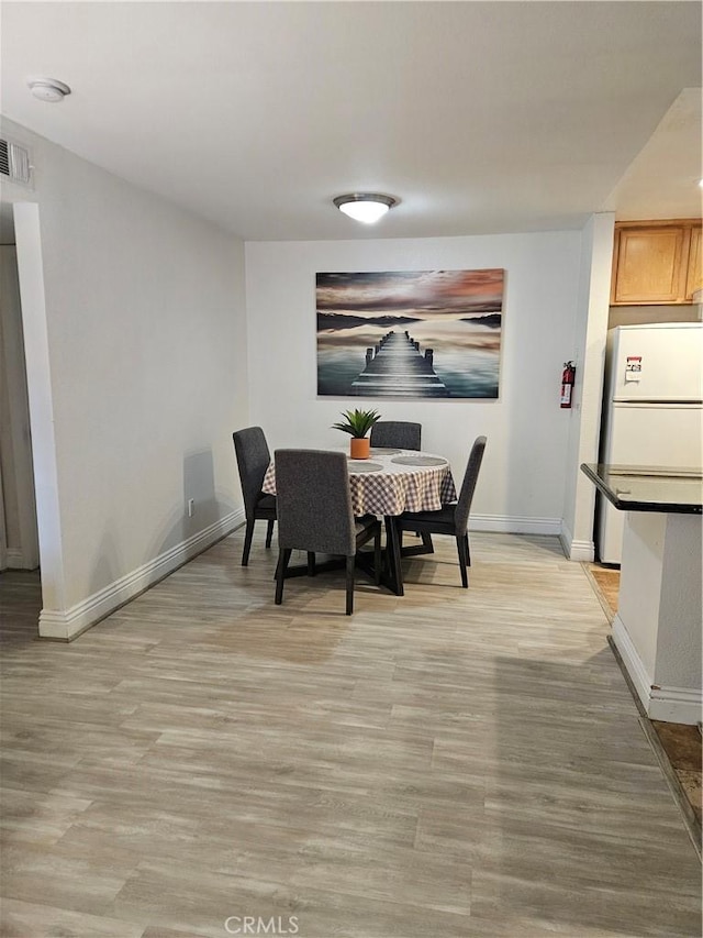 2350 Del Mar Way Unit 103, Corona, CA 92882 - dining space with light wood-style flooring