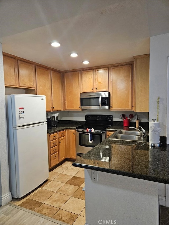 2350 Del Mar Way Unit 103, Corona, CA 92882 - kitchen featuring appliances with stainless steel finishes, a peninsula, dark stone countertops, and recessed lighting