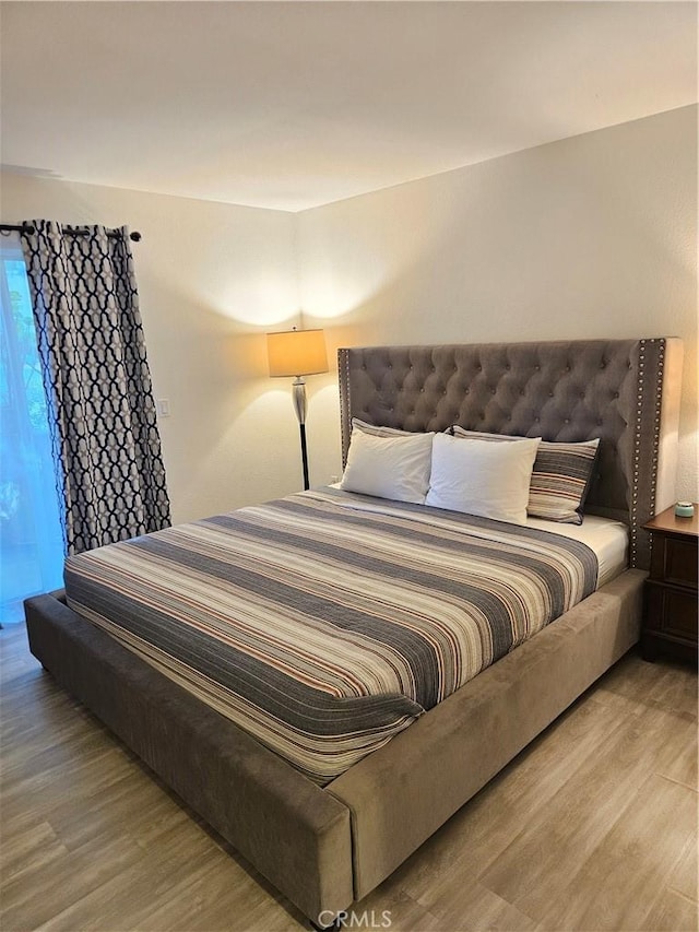 2350 Del Mar Way Unit 103, Corona, CA 92882 - bedroom featuring wood finished floors and access to exterior