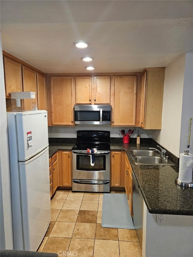 2350 Del Mar Way Unit 103, Corona, CA 92882 - kitchen featuring stainless steel appliances, recessed lighting, light tile patterned floors, and dark stone countertops