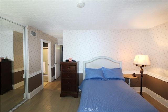 23281 Via Bahia, Mission Viejo, CA 92691 - bedroom with wood finished floors, wallpapered walls, and a textured ceiling