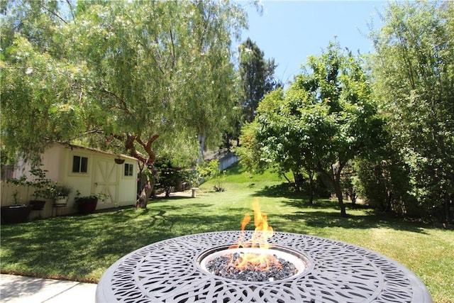 23281 Via Bahia, Mission Viejo, CA 92691 - view of grassy yard featuring a fire pit, an outdoor structure, and view of wooded area