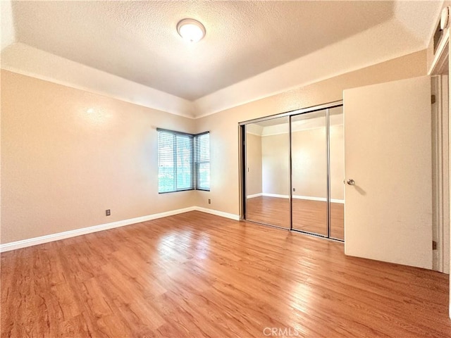 22749 Lakeway Dr Unit 375, Diamond Bar, CA 91765 - unfurnished bedroom featuring light wood-style flooring, a closet, and a textured ceiling