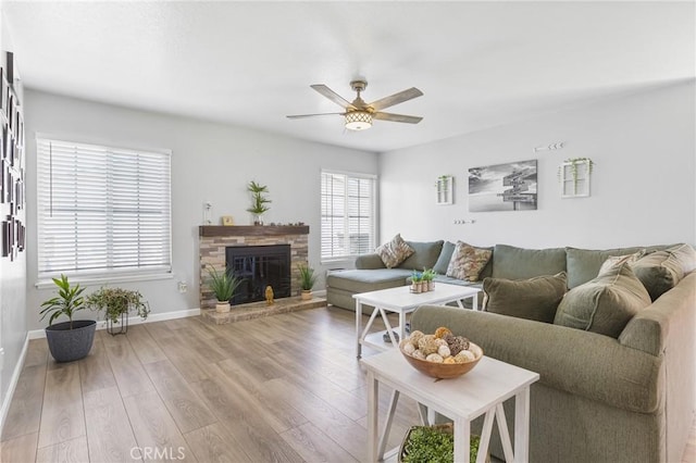 2951 S Plainfield Pl, Ontario, CA 91761 - living area featuring a ceiling fan, wood finished floors, and a stone fireplace