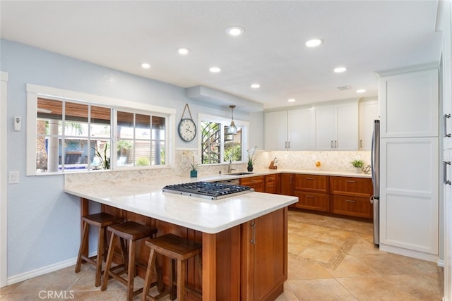 1225 Old Hickory Rd, Corona, CA 92882 - kitchen featuring a peninsula, stainless steel appliances, decorative backsplash, light countertops, and recessed lighting